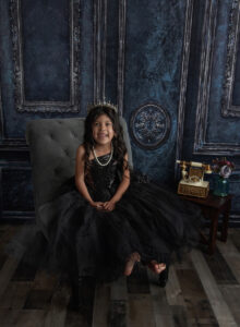 Austin Baby Photographer girl in black dress sitting on chair