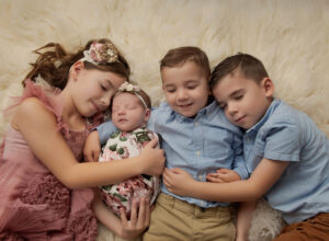 Austin Newborn Photographer baby girl in floral wrap with 3 older siblings